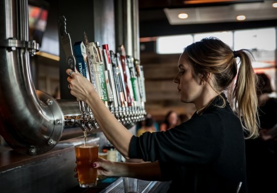 The Mainstay bartender pouring a draft beer